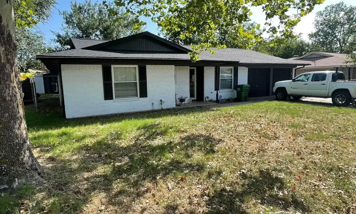 Professional roofing crew working on a residential roof in Denair